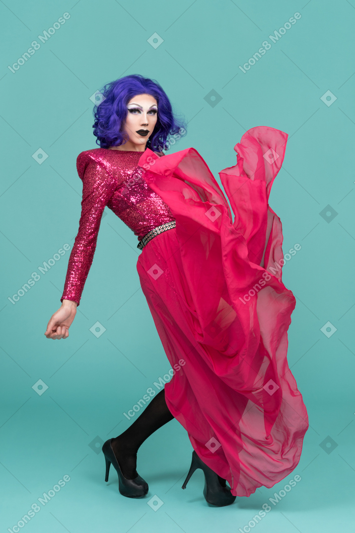 Drag queen in pink maxi skirt leaning backwards