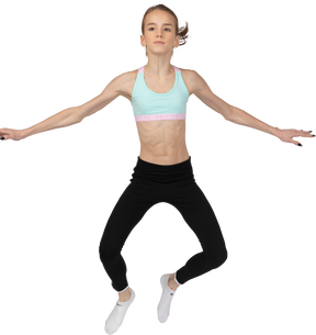 一个年轻的女孩，在运动服跳的前视图