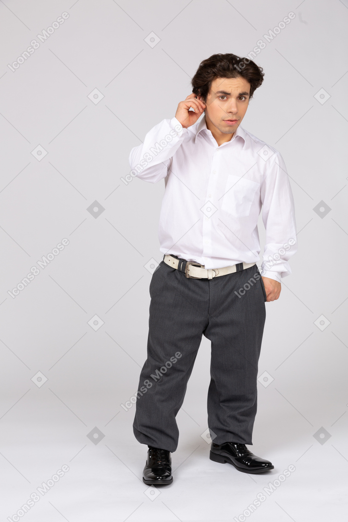 Young office worker touching his ear