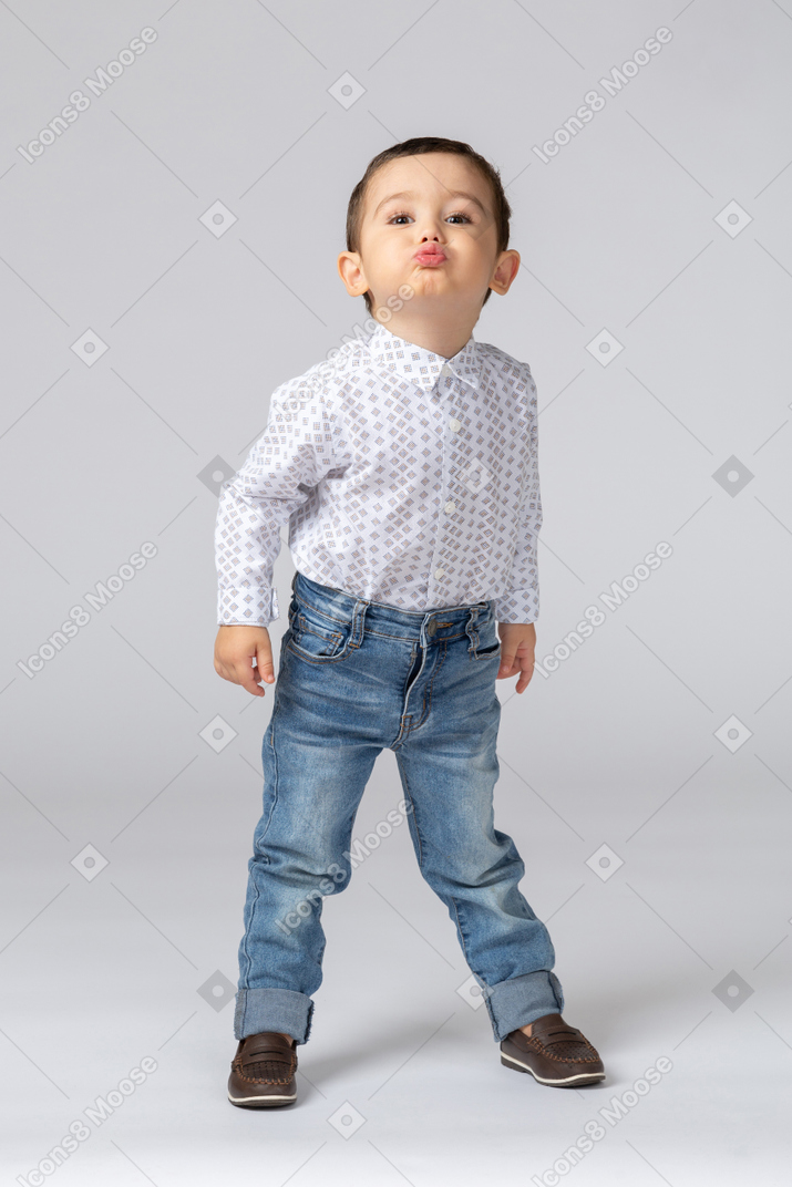 Little kid standing with a provoking look