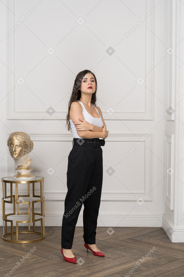 Young businesswoman standing with hands crossed