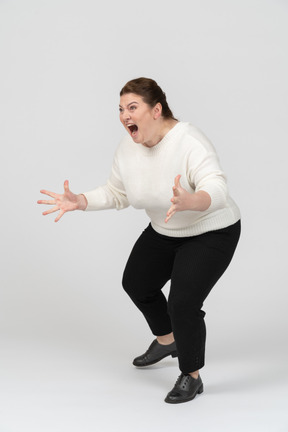 Angry plump woman in casual clothes fighting