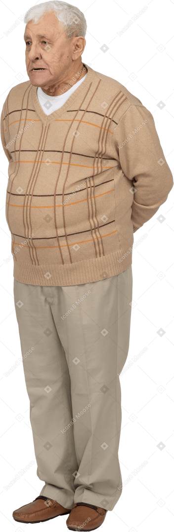 Front view of an old man in casual clothes making faces