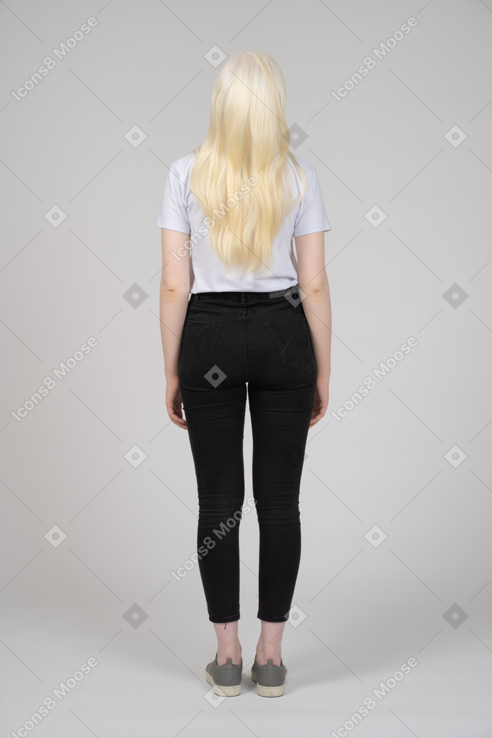 Back view of a long-haired girl with arms at sides