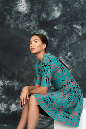 Young woman in blue sitting and thinking about the future