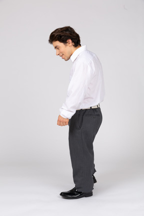 Side view of a smiling office worker leaning forward