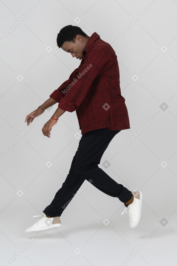 Side view of black man jumping