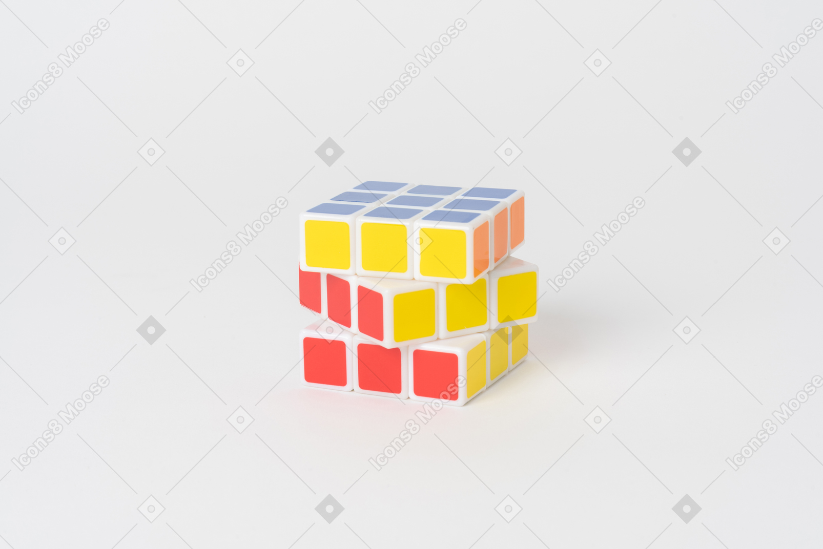A rubik's cube puzzle lying against a plain white background