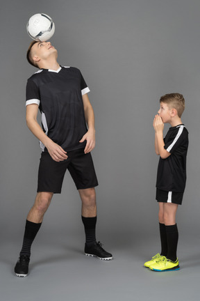 Full-length of a young man coaching little boy