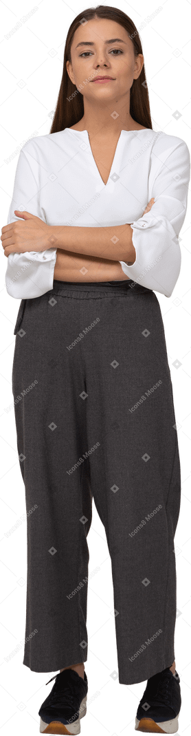 Front view of a thoughtful young lady in office clothing crossing arms