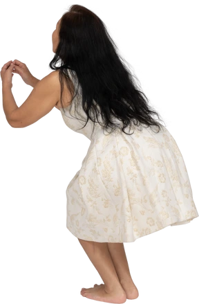 Woman in beautiful dress jumping