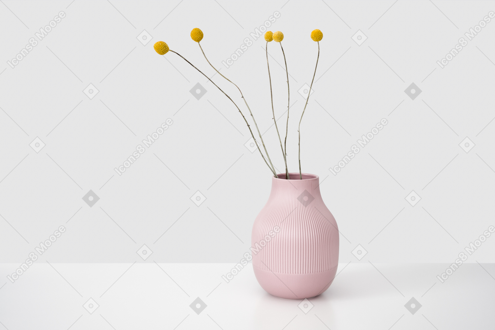 Dried flowers in a pink ceramic vase
