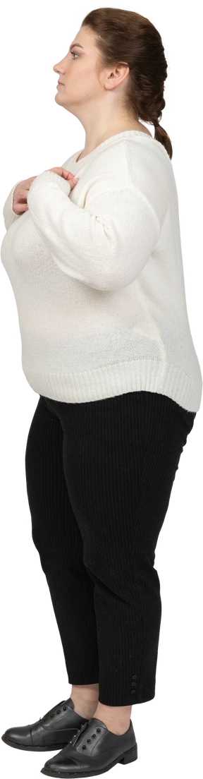 Side view of a serious plump woman in casual clothes