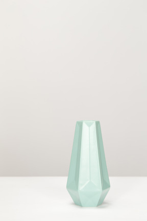 Empty grey vase on white table