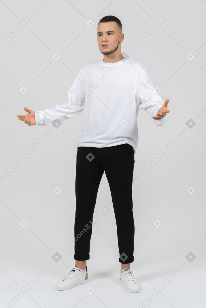 Excited young man in casual clothes gesturing