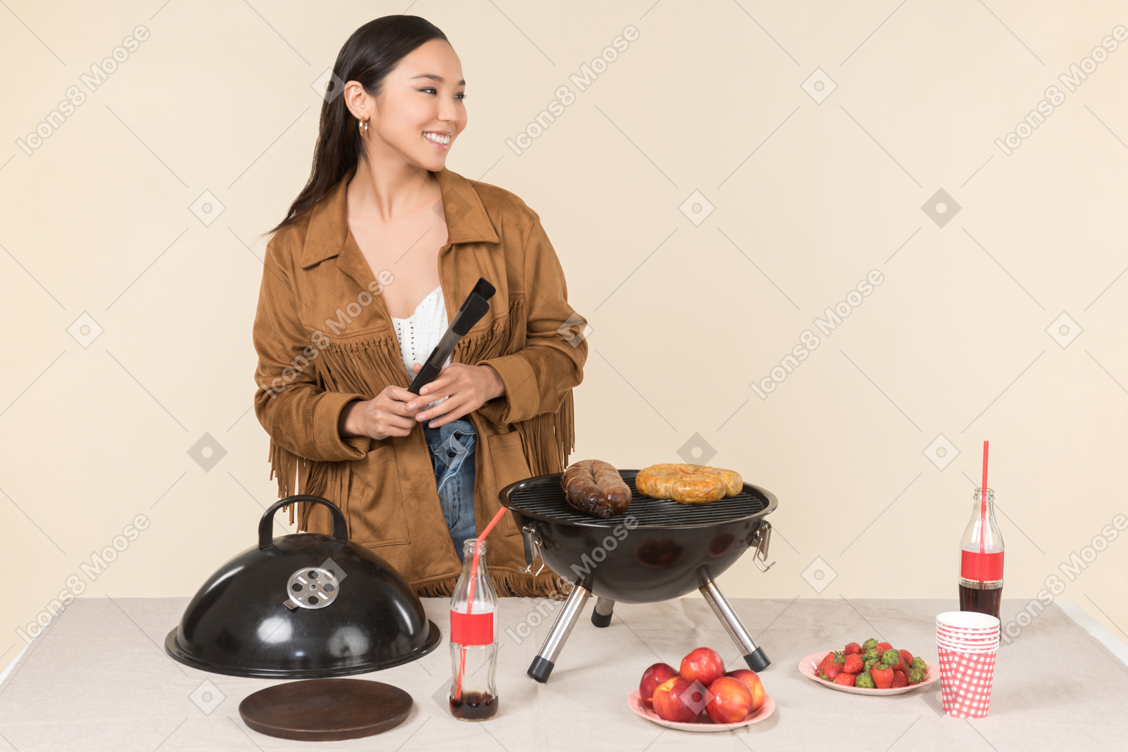 Smiling young asian woman doing bbq