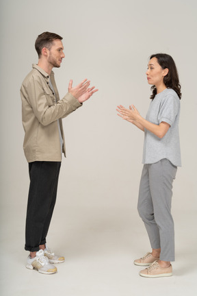 Side view of young couple speaking to each other