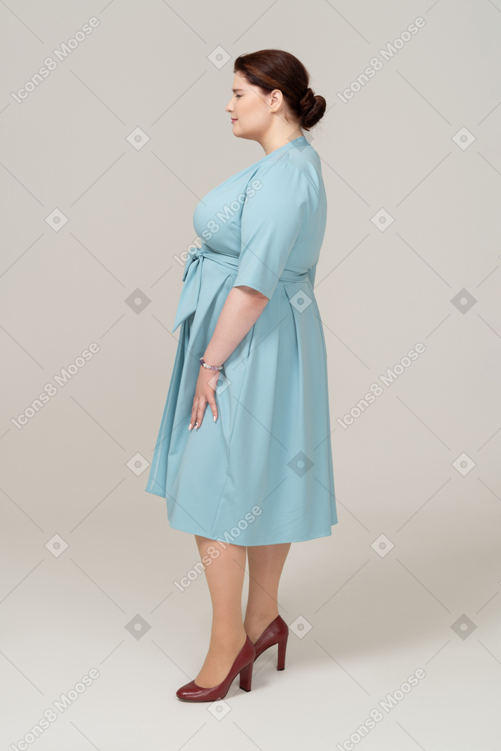 Vista lateral de uma mulher de vestido azul