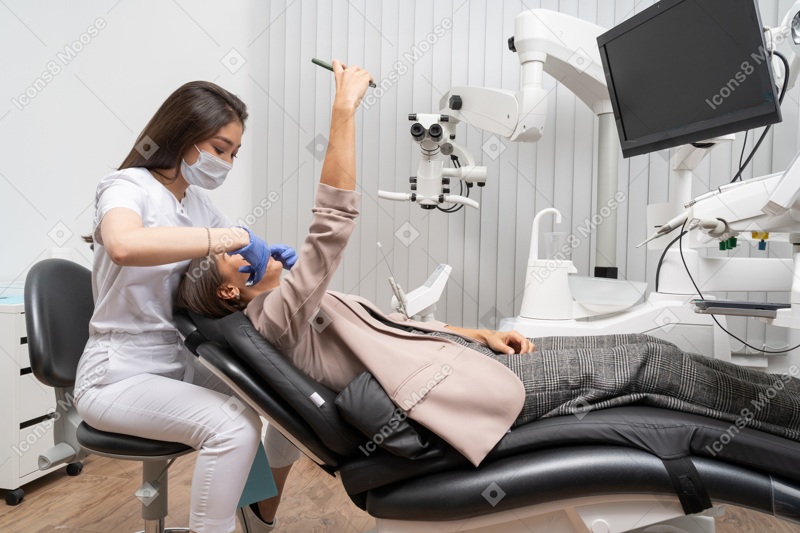 Full-length of a female dentist examining her patient making selfie