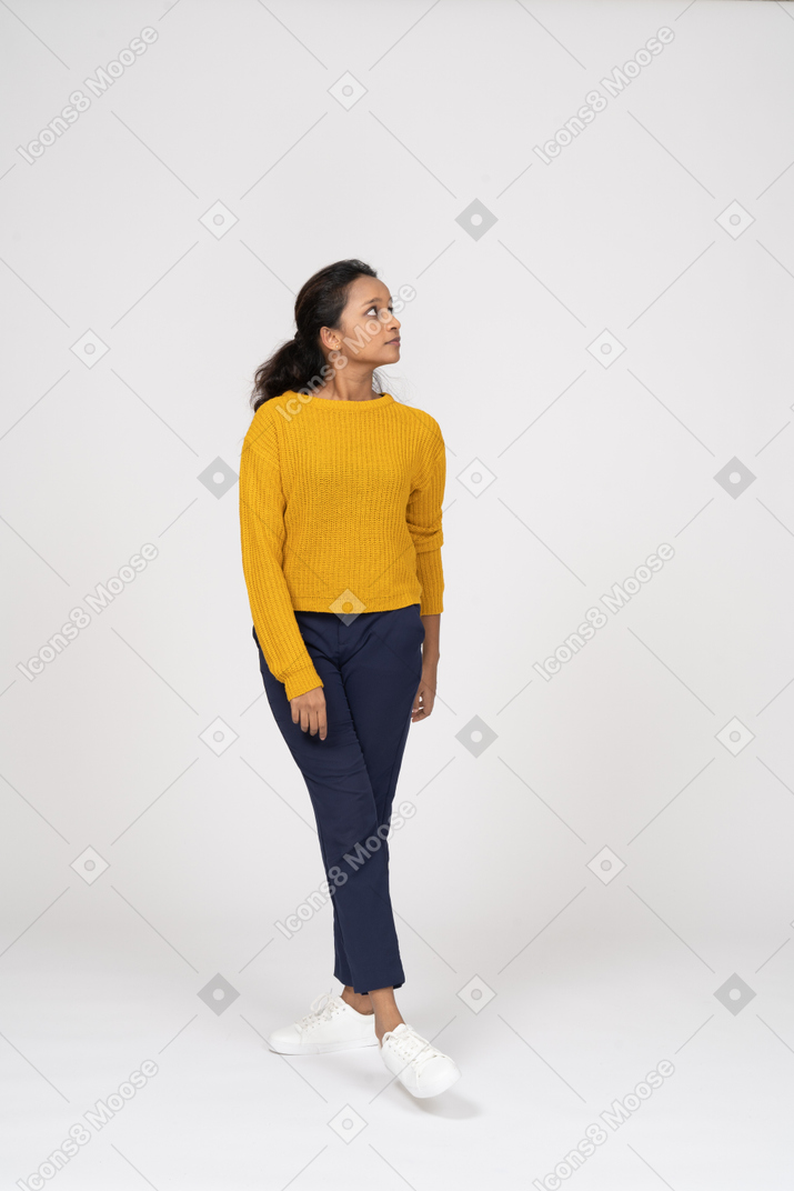 Front view of a girl in casual clothes looking up