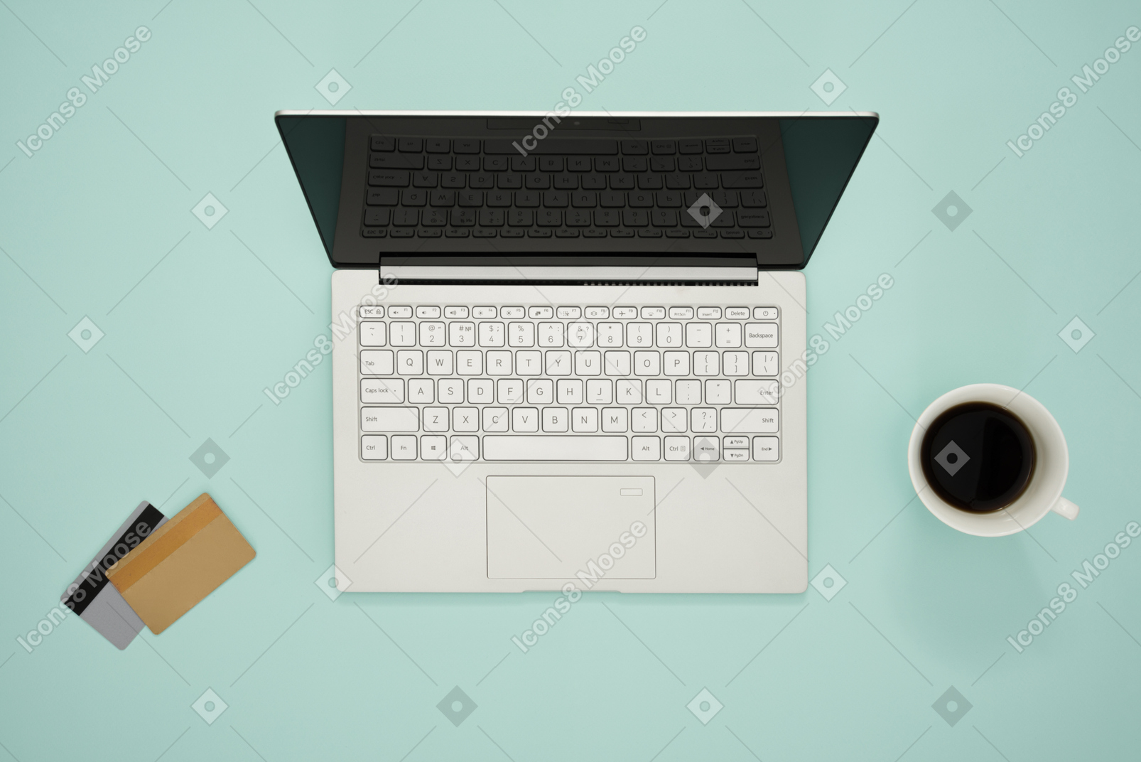 Laptop and credit cards on a turquoise background