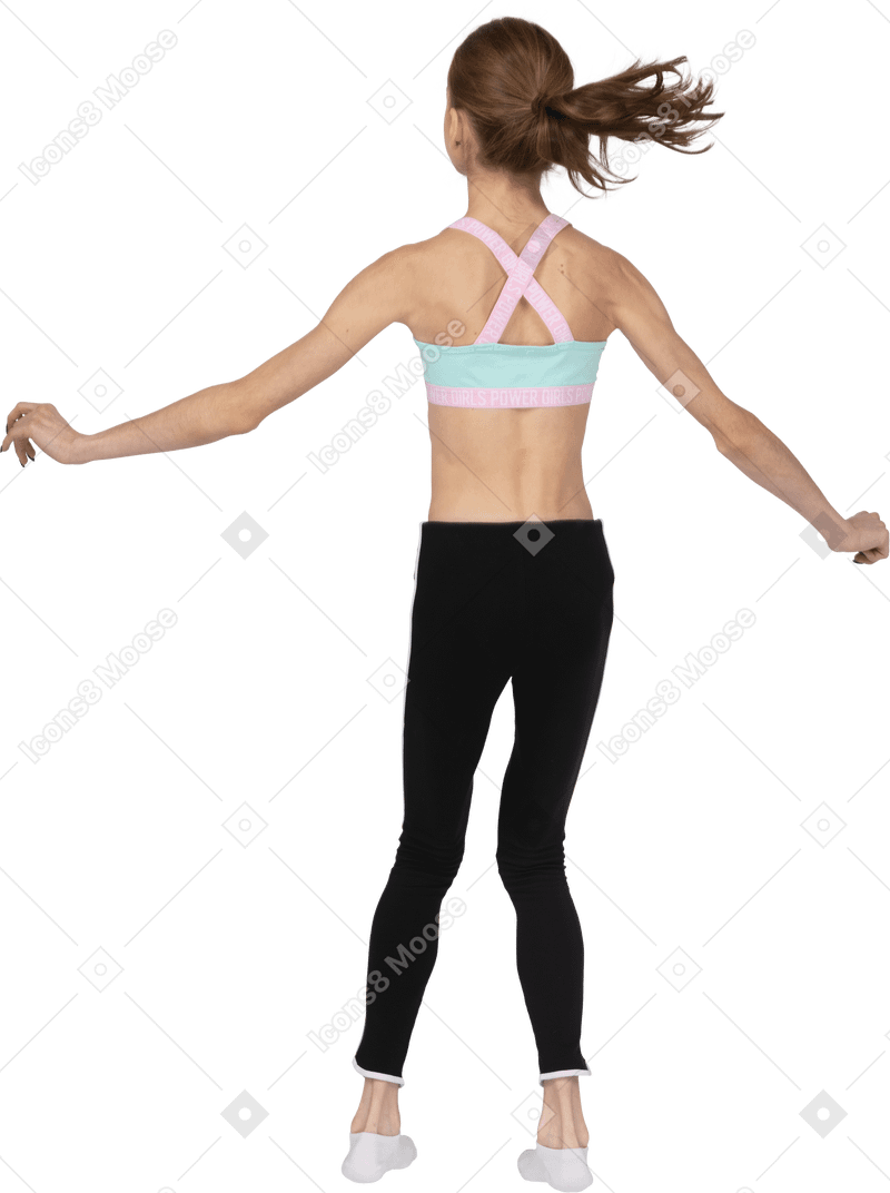 Vista posterior de una jovencita en ropa deportiva saltando