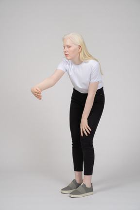Young woman reaching her arm out