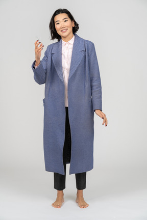 Smiling woman in blue coat gesturing