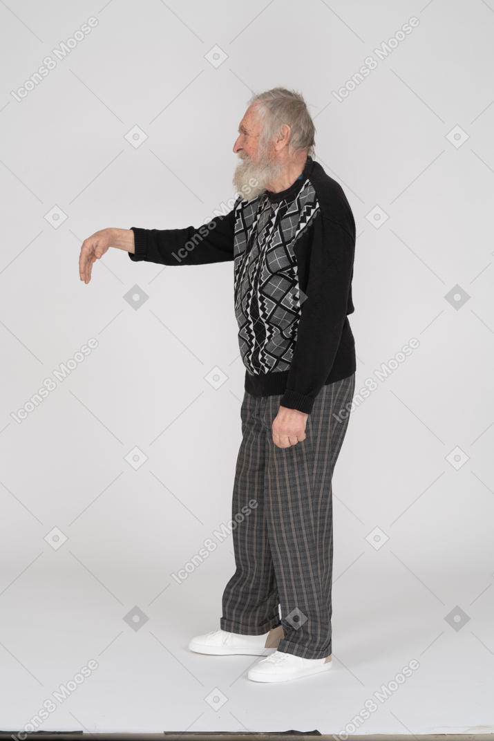 Side view of old man gesturing with hand