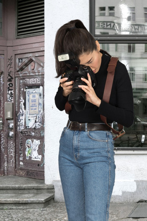 A woman is taking a picture with a camera