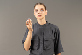 Front view of a young woman in a jumpsuit removing make-up