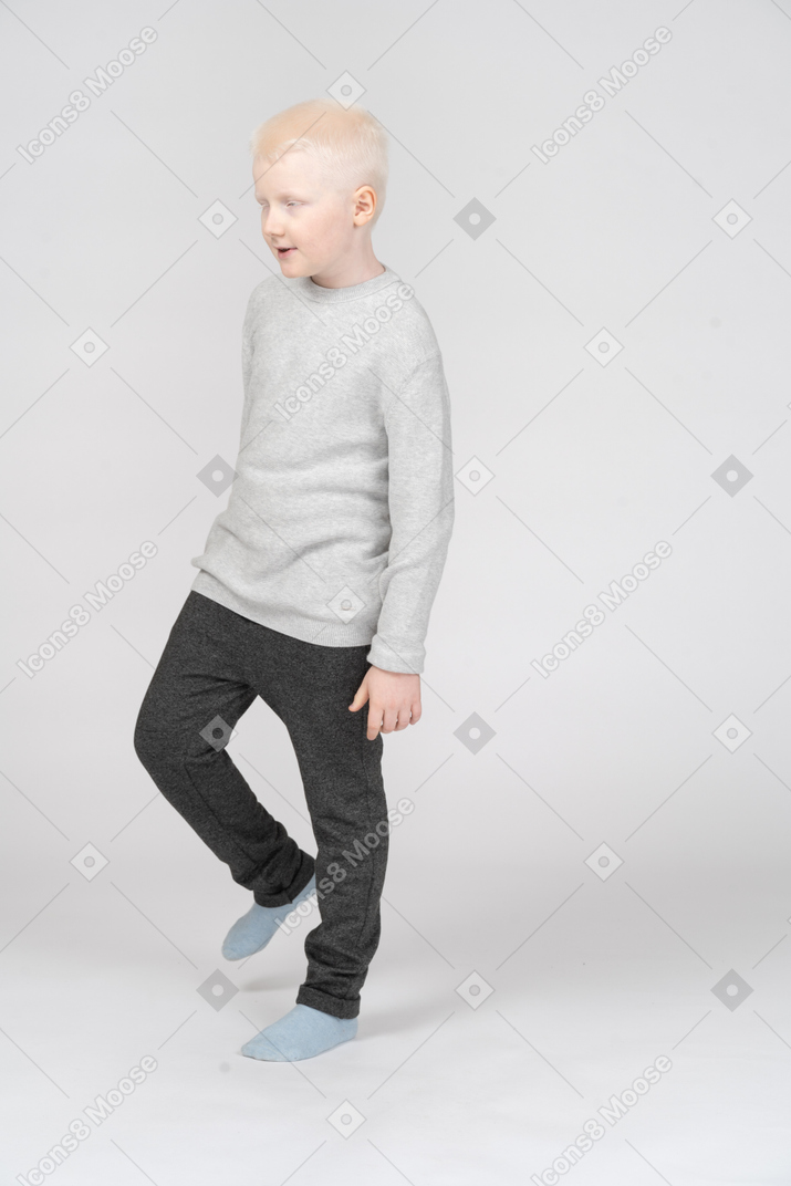 Three quarter view of a little boy walking