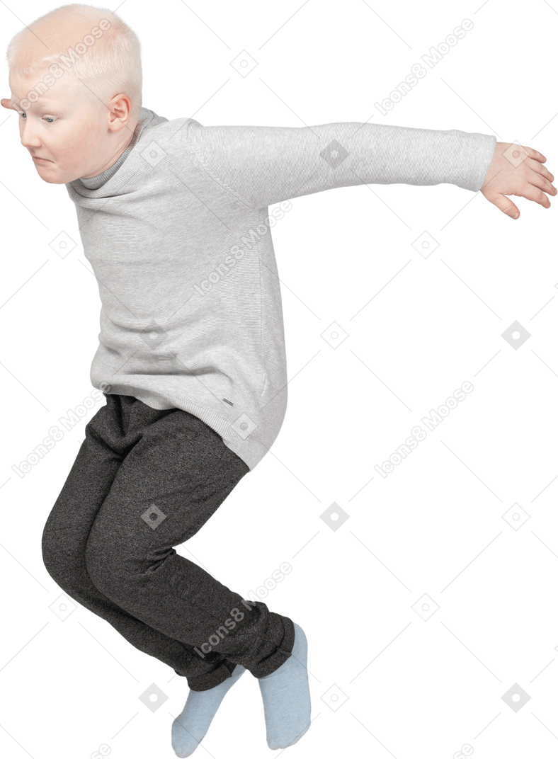 Three-quarter view of a boy jumping high
