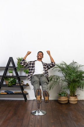 Good looking young man sitting on a chair