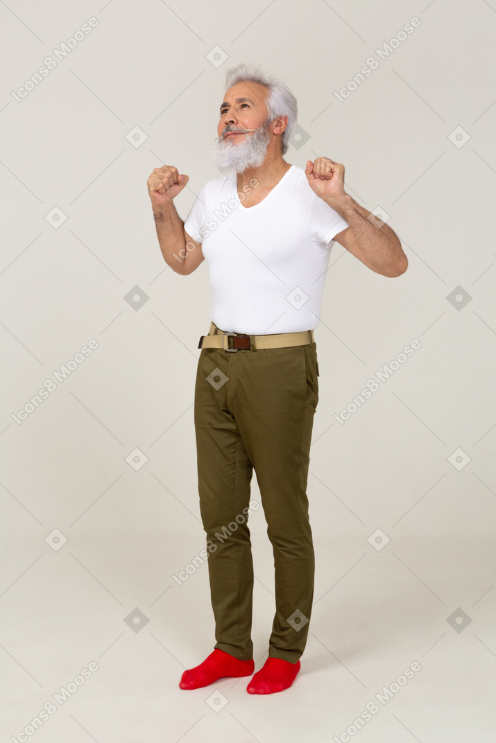 Cheerful man in casual clothing stretching his arms