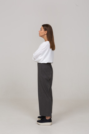 Side view of a serious young lady in office clothing looking aside