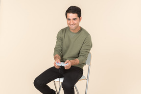 Young caucasian guy playing a videogame