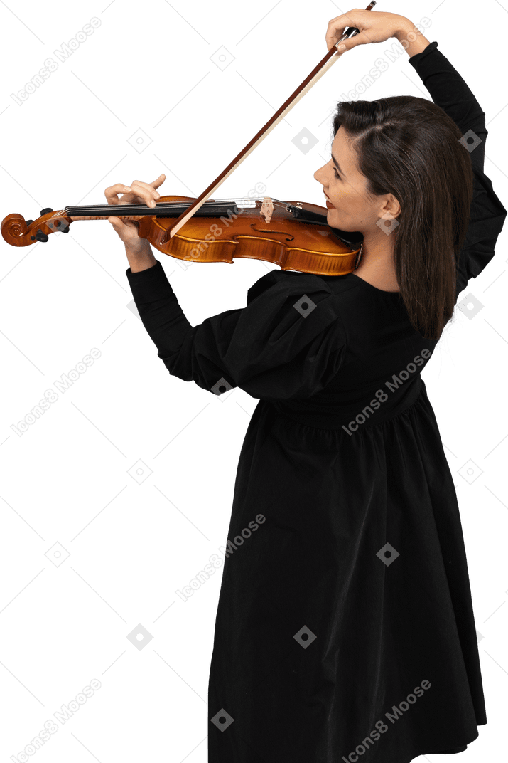 Close-up of a young cheerful lady in black dress playing the violin