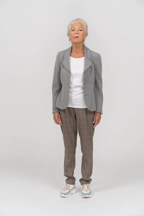 Front view of an old lady in suit looking at camera