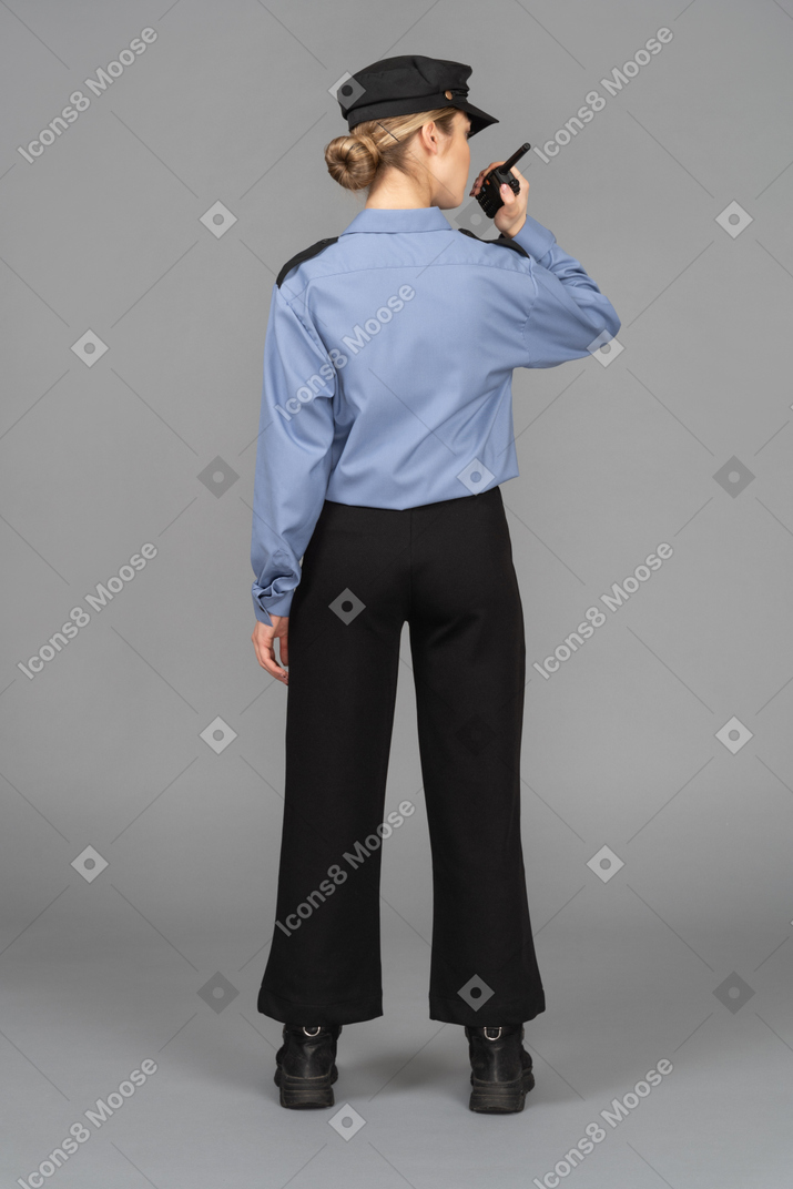 Female security guard holding a radio
