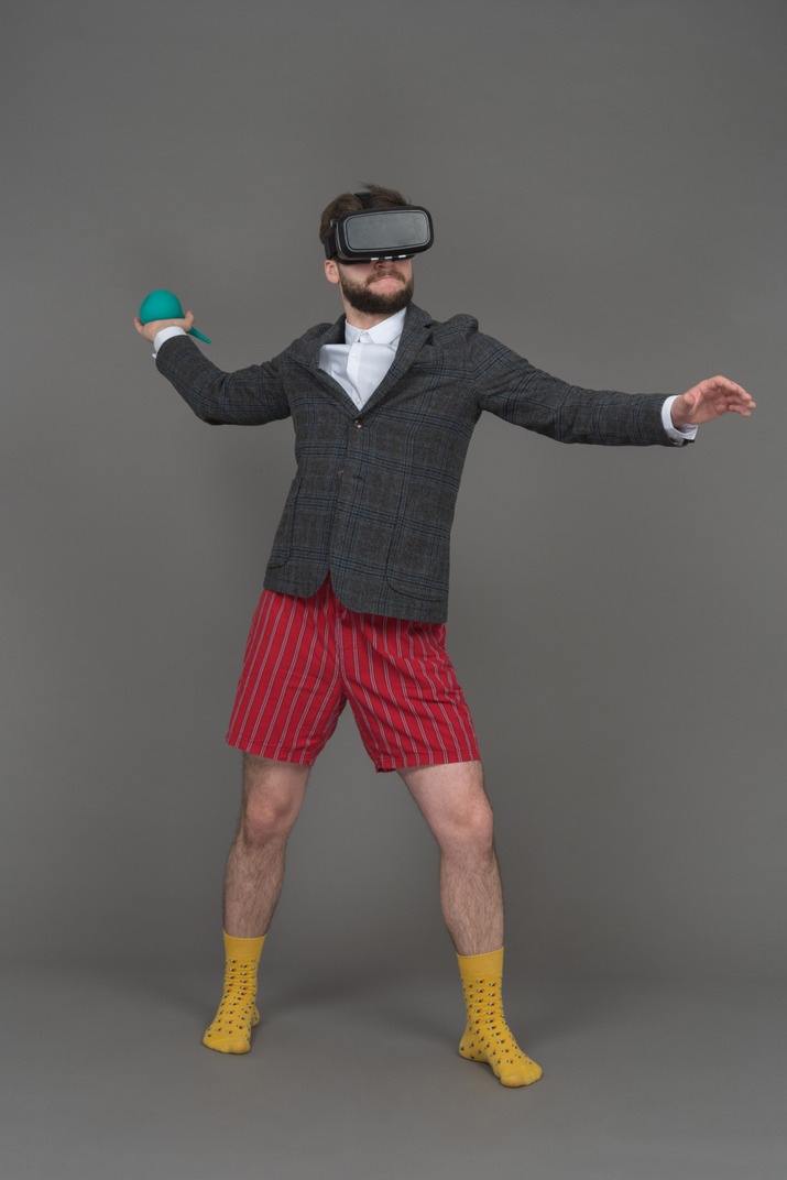 Man in vr headset is ready to throw the object