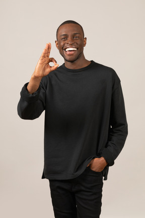 Smiling man showing ok gesture