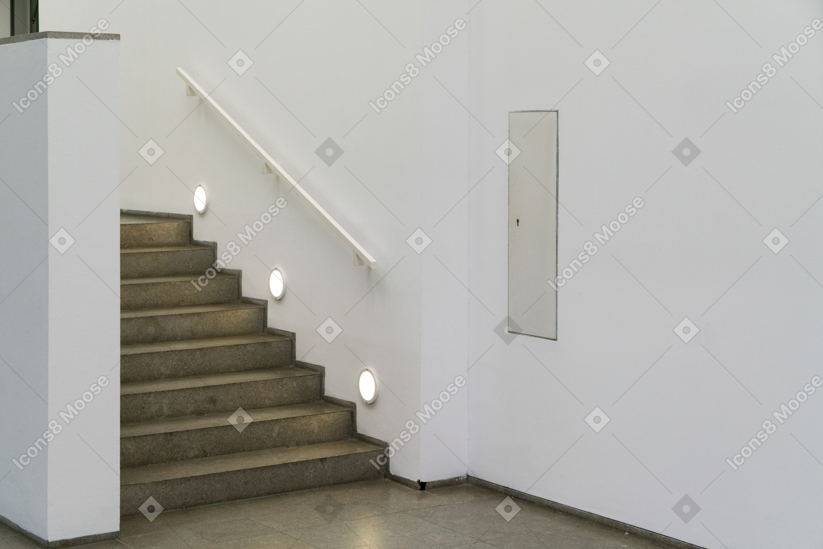 Staircase lighting in a white hallway