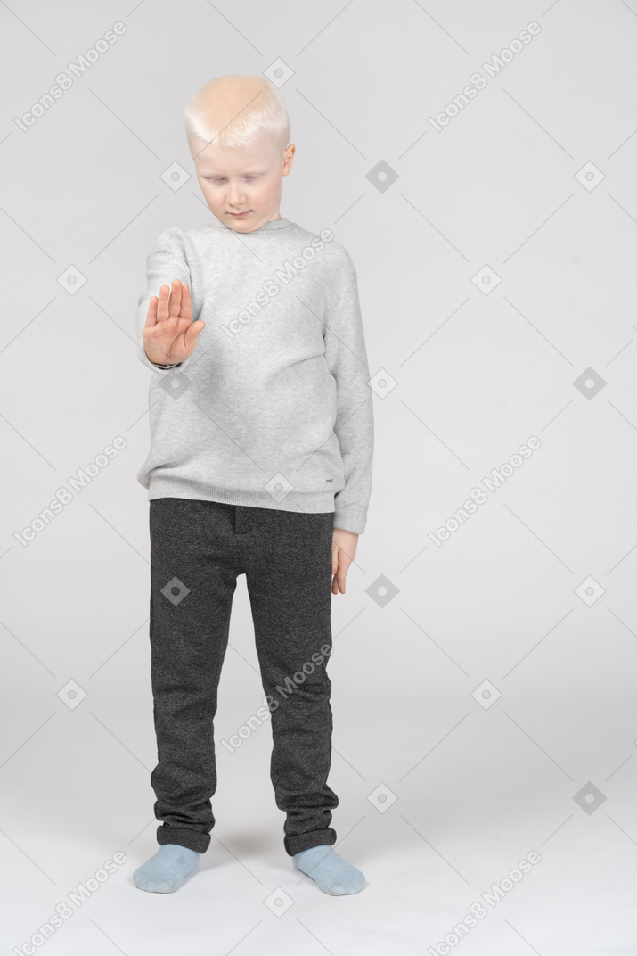Little boy with his arm outstretched and eyes closed