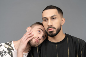 Young man putting his head on boyfriend's shoulder