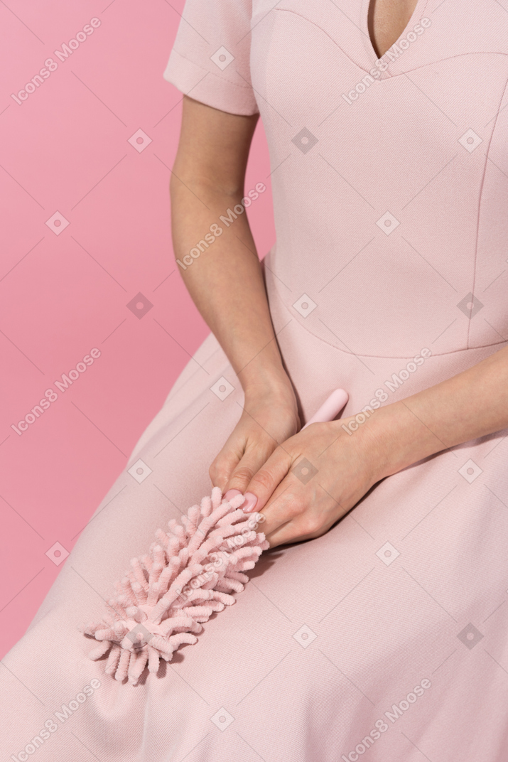 Holding a pink bottle brush
