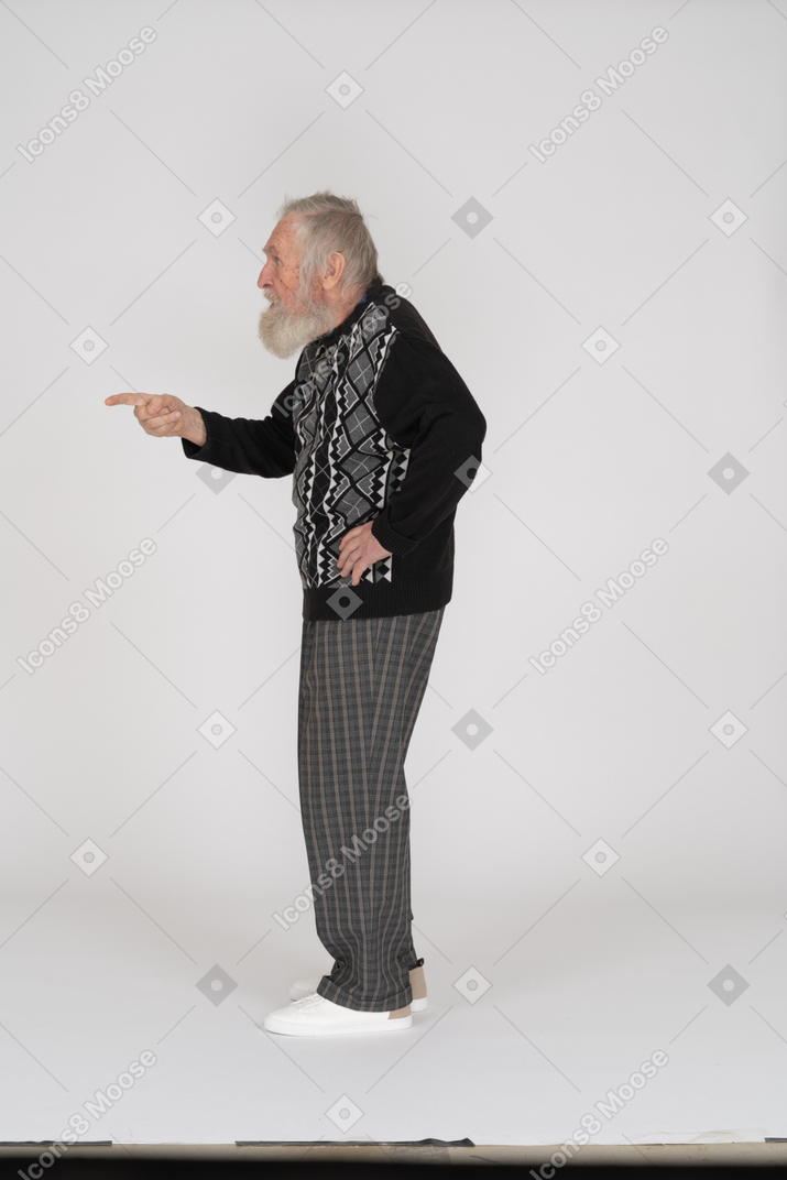 Side view of an old man pointing to the left