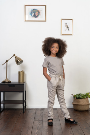 Good looking girl kid posing on the apartment background