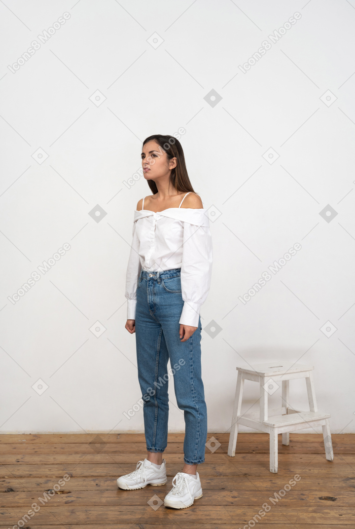Woman in jeans and shirt standing in a room