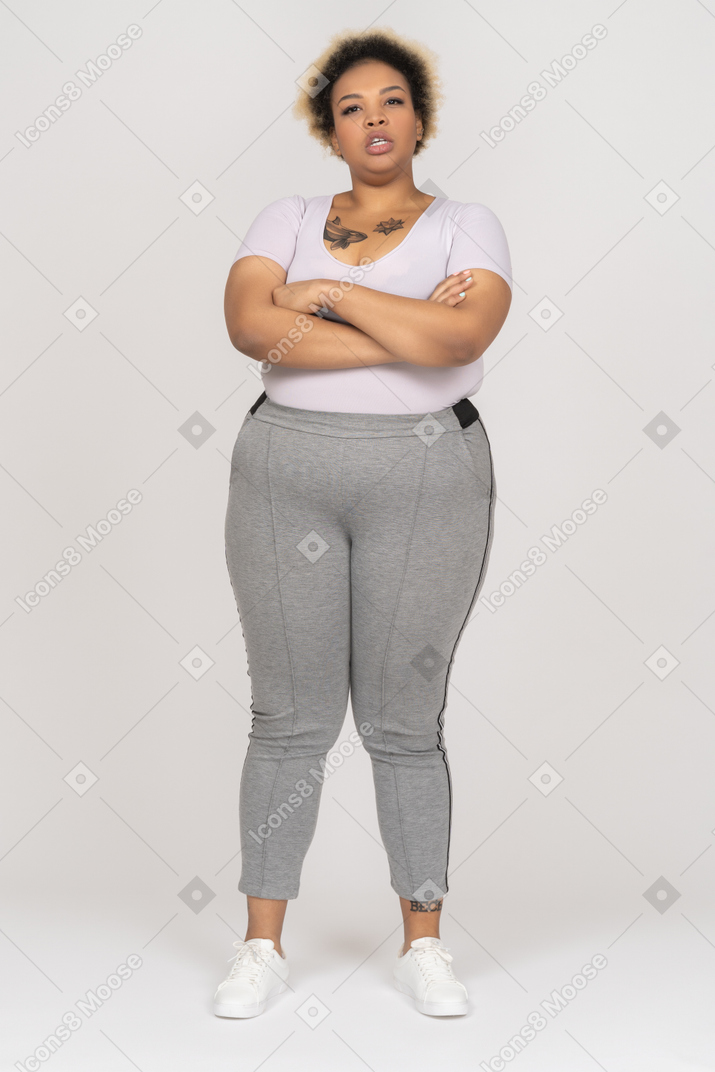 Frown plump woman posing with crossed arms